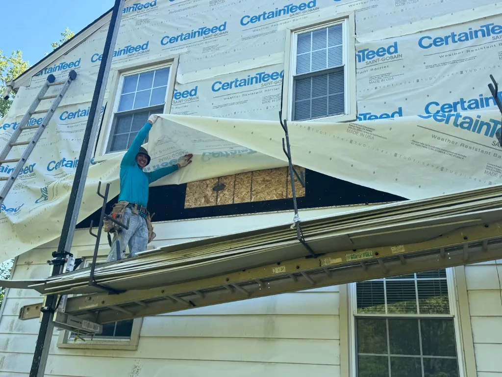 J&Hong crew installing weather-resistant barrier and siding on a home